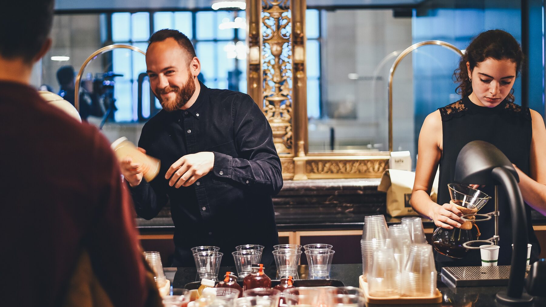 TipsyTee bartenders mixing drinks at a bright event bar