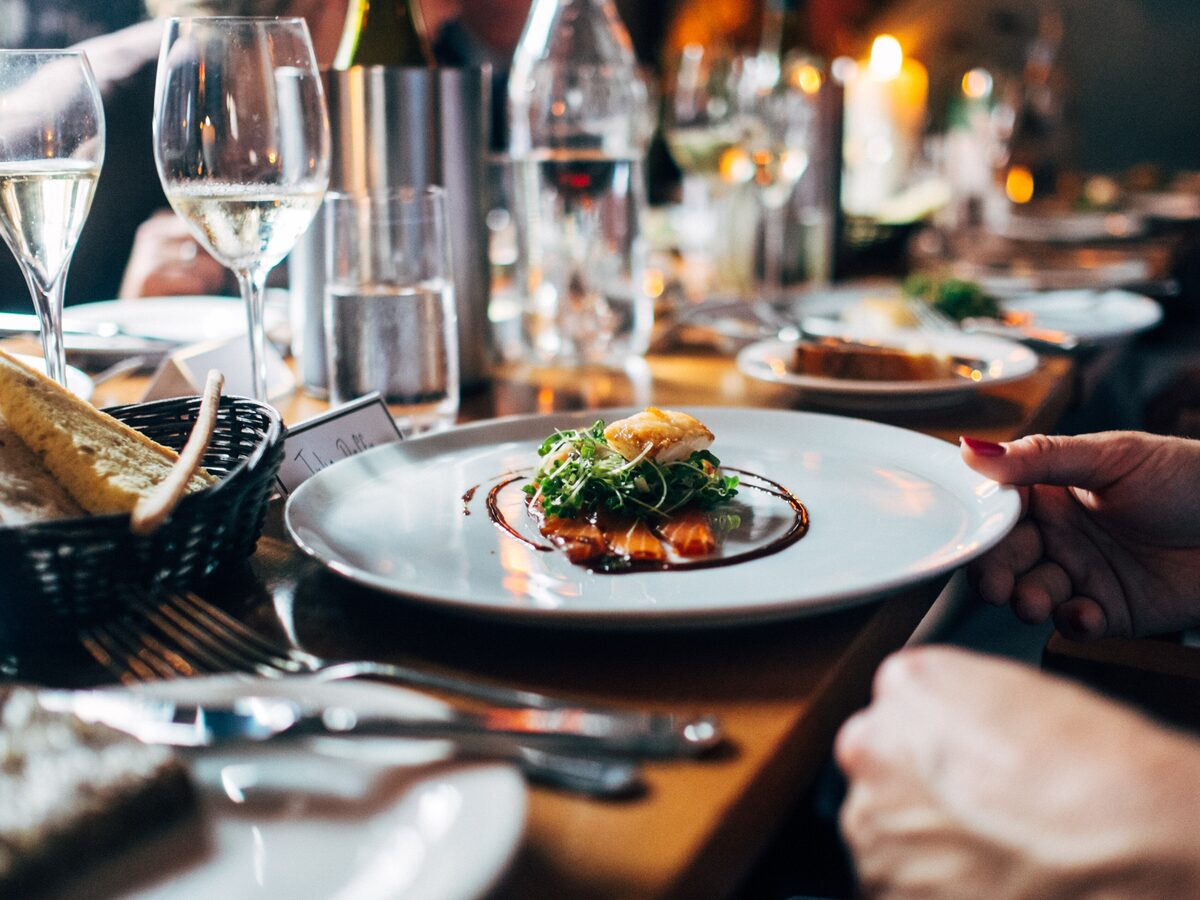 Plated course being served at a candlelit dinner